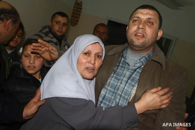Ayman Nofal (L) , a top Hamas armed commander, is greeted by his mother upon his arrival to his home in Nusairat in the Central Gaza strip February 5, 2011. A senior Hamas commander returned to the Gaza Strip on Saturday...