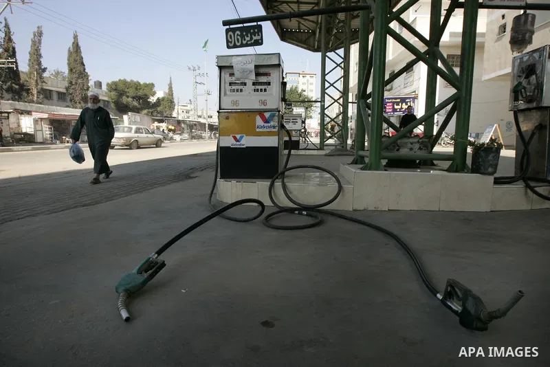 Palestinian man walks past in a petrol station in Rafah, southern Gaza Strip on February, 06, 2011. Fuel stations in the Gaza Strip free of fuel, due to suspension of the fuel line through border tunnels between Egypt an...