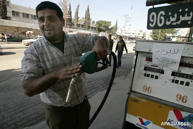 A Palestinian worker stands in his petrol station in Rafah, southern Gaza Strip on February, 06, 2011. Fuel stations in the Gaza Strip free of fuel, due to suspension of the fuel line through border tunnels between Egypt...