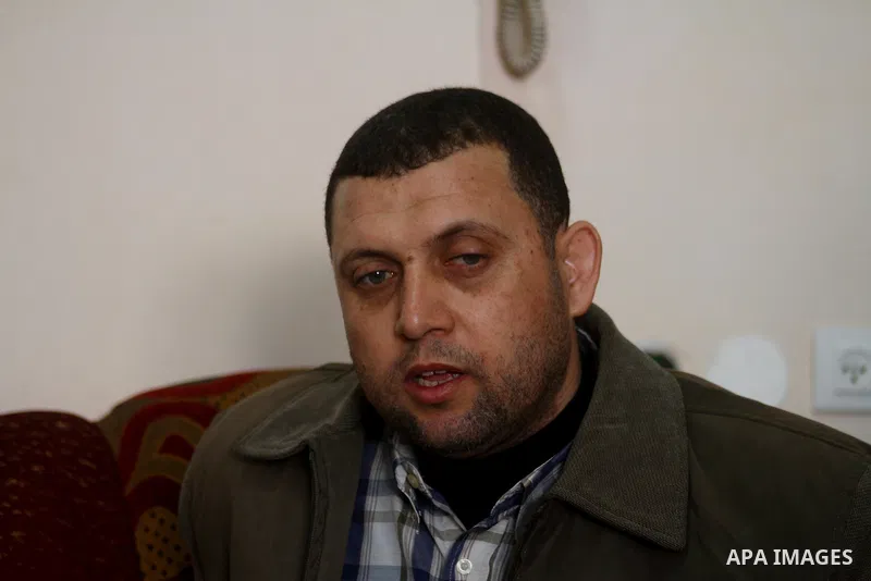 Ayman Nofal (C), a top Hamas armed commander, sits with his family (not seen) at his home in Nusairat in the Central Gaza strip on February 6, 2011. A senior Hamas commander returned to the Gaza Strip on Saturday after b...