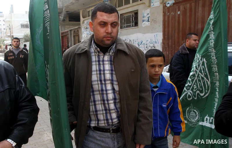 Ayman Nofal , a top Hamas armed commander, walks with his son near his home in Nusairat in the Central Gaza strip February 6, 2011. A senior Hamas commander returned to the Gaza Strip on Saturday after breaking out of a...