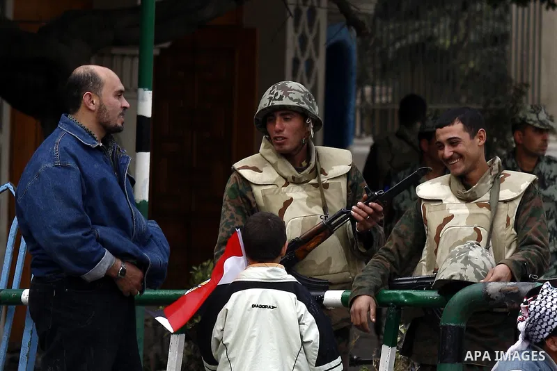 Egyptian soldiers stand guards at Tahrir Square in Cairo Feb. 6, 2011. Demonstrators camped out in Cairo's Tahrir Square, which has become an epicentre for protest, vowed to intensify their battle to oust Egypt's Preside...