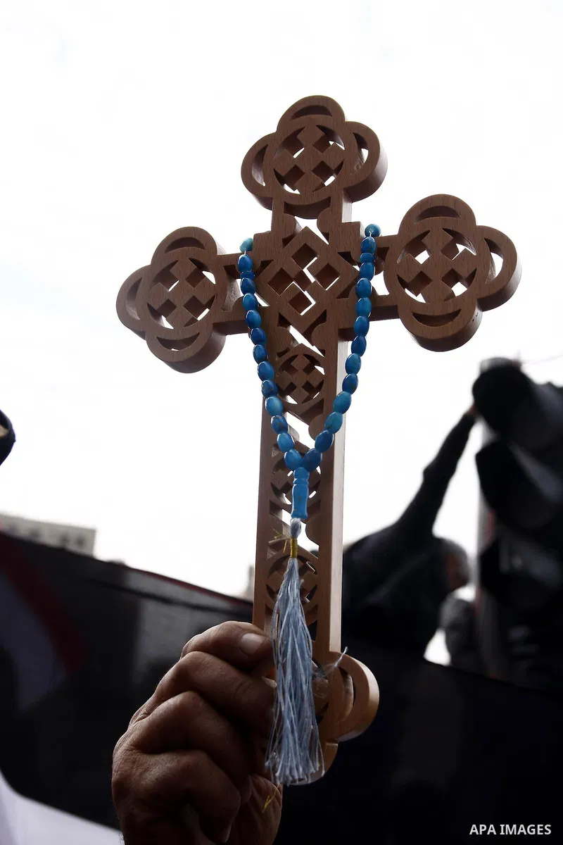 An opposition supporter holds a cross in Tahrir Square in Cairo February 6, 2011. Demonstrators camped out in Cairo's Tahrir Square, which has become an epicentre for protest, vowed to intensify their battle to oust Egyp...