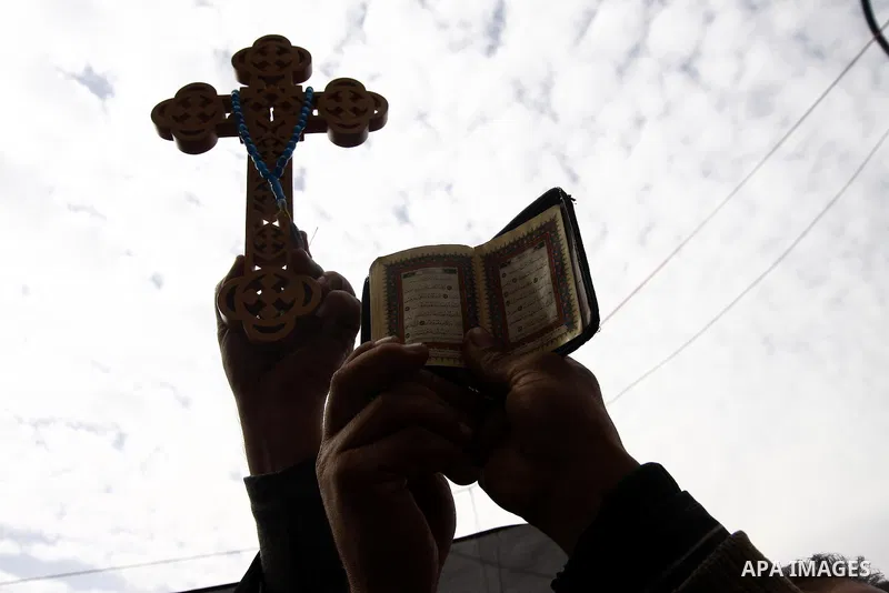 Opposition supporters hold Holy Quran and a cross in Tahrir Square in Cairo February 6, 2011. Demonstrators camped out in Cairo's Tahrir Square, which has become an epicentre for protest, vowed to intensify their battle...
