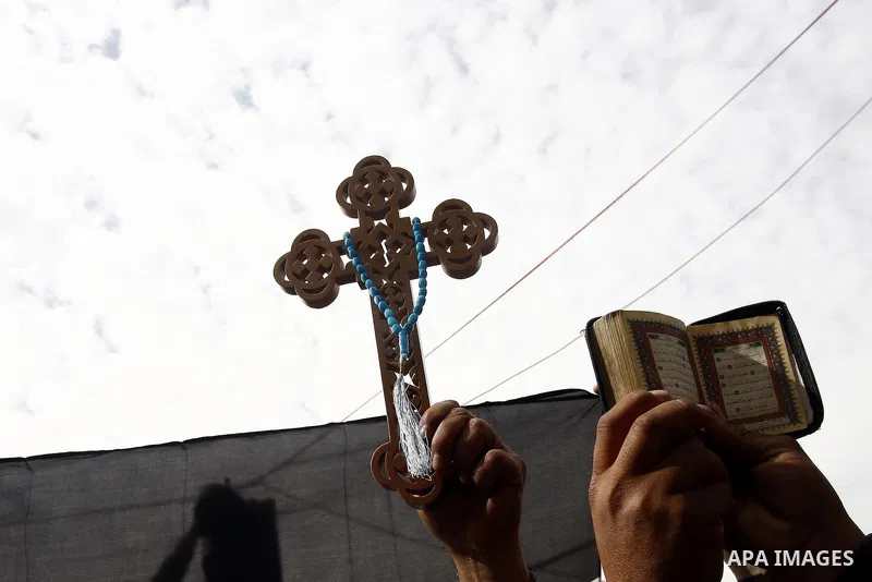 Opposition supporters hold Holy Quran and a cross in Tahrir Square in Cairo February 6, 2011. Demonstrators camped out in Cairo's Tahrir Square, which has become an epicentre for protest, vowed to intensify their battle...