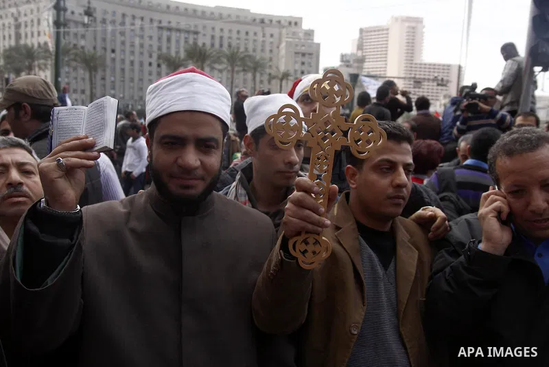 Opposition supporters hold Holy Quran and a cross in Tahrir Square in Cairo February 6, 2011. Demonstrators camped out in Cairo's Tahrir Square, which has become an epicentre for protest, vowed to intensify their battle...