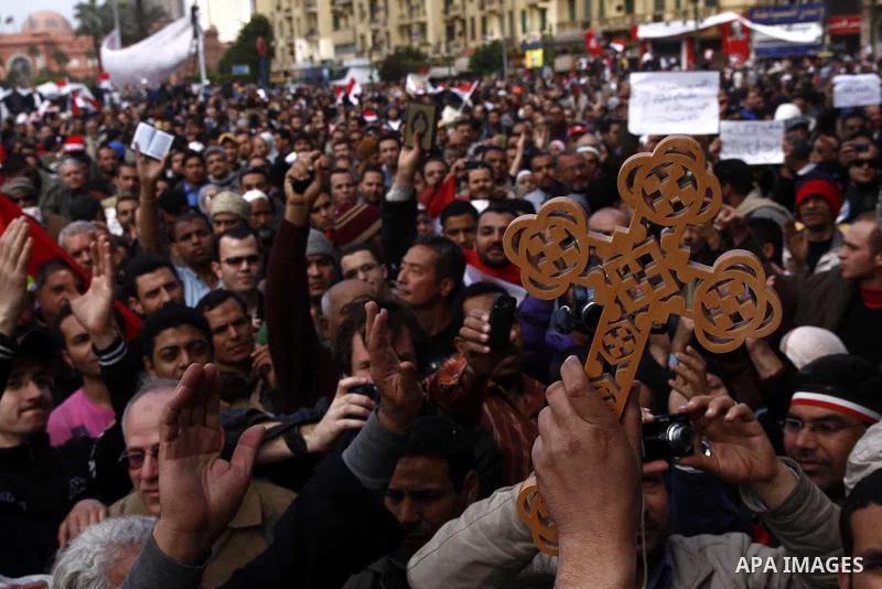 Opposition supporters hold Holy Quran and a cross in Tahrir Square in Cairo February 6, 2011. Demonstrators camped out in Cairo's Tahrir Square, which has become an epicentre for protest, vowed to intensify their battle...