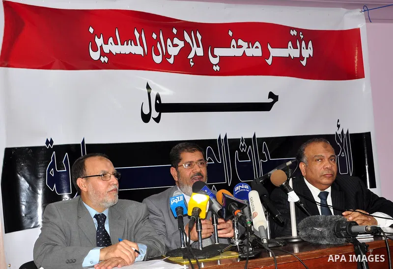 Egyptian Muslim brotherhood seniors Saad el-Katatni, right, Essam el-Erian, left, and Mohamed Morsi talk during a press conference in Cairo, Egypt, Sunday, Feb. 6, 2011. Egypt's largest opposition group, the Muslim Broth...