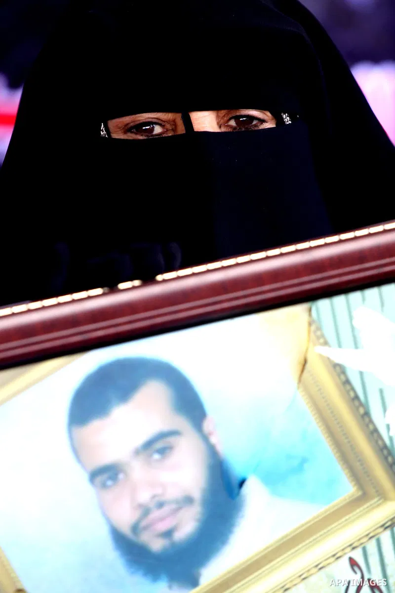 Palestinian women hold pictures of jailed relatives during a protest calling for the release of Palestinian prisoners from Israeli jails at the Red Cross office in Gaza City on Feb. 7,2011. Photo by Mohammed Asad
