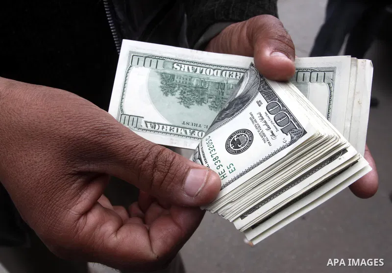 A Palestinian man exchanges money in front of the National Islamic bank in Gaza city on Feb. 7,2011. Photo by Mohammed Asad