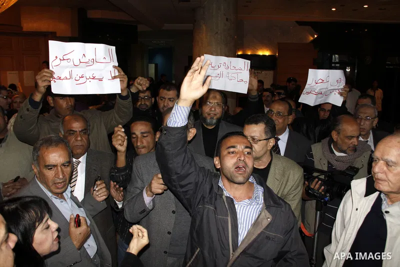 People take part in a symbolic funeral ceremony for the Egyptian journalist, Ahmed Mohammed Mahmoud in Tahrir Square, Cairo, Egypt, Monday, Feb. 7, 2011. The reporter who was shot during clashes a week ago died of his wo...