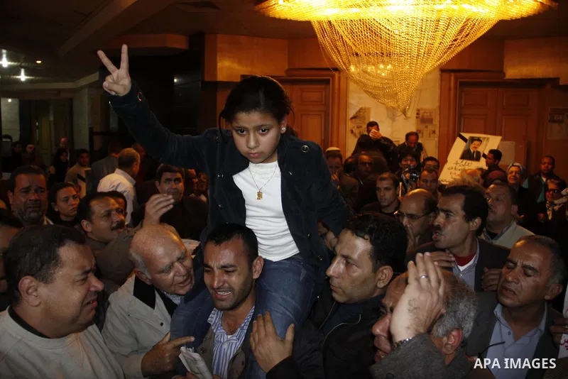 The daughter of the Egyptian journalist, Ahmed Mohammed Mahmoud takes part in a symbolic funeral ceremony for her father in Tahrir Square, Cairo, Egypt, Monday, Feb. 7, 2011. The reporter who was shot during clashes a we...