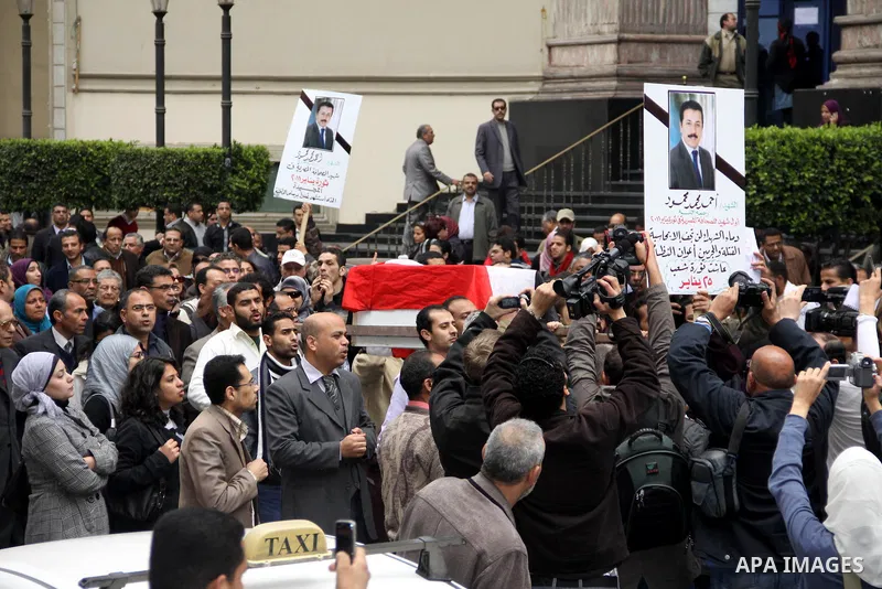 People carry a symbolic coffin of Egyptian journalist Ahmed Mohammed Mahmoud, in symbolic funeral ceremony in Tahrir Square, Cairo, Egypt, Monday, Feb. 7, 2011. The reporter who was shot during clashes a week ago died of...