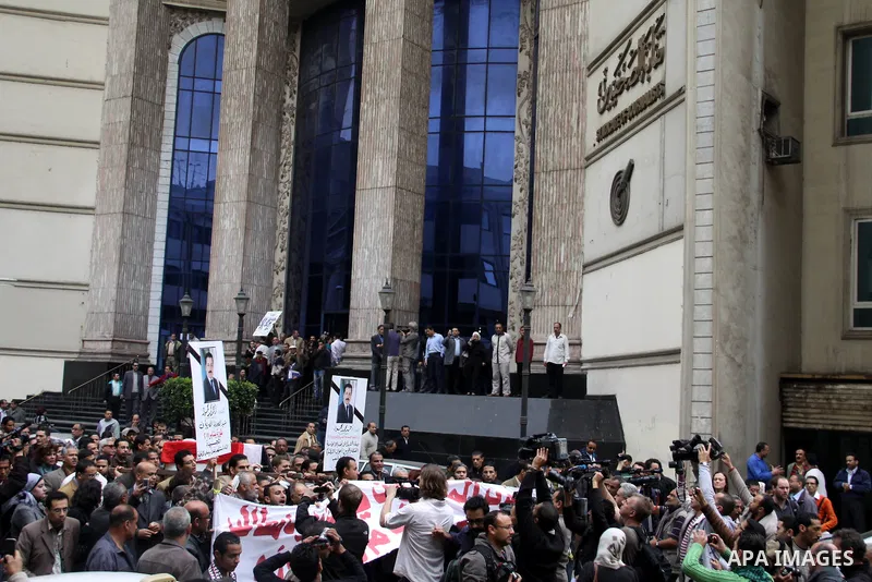 People carry a symbolic coffin of Egyptian journalist Ahmed Mohammed Mahmoud, in symbolic funeral ceremony in Tahrir Square, Cairo, Egypt, Monday, Feb. 7, 2011. The reporter who was shot during clashes a week ago died of...