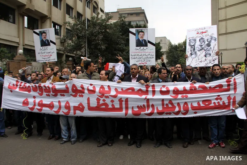 People carry a symbolic coffin of Egyptian journalist Ahmed Mohammed Mahmoud, in symbolic funeral ceremony in Tahrir Square, Cairo, Egypt, Monday, Feb. 7, 2011. The reporter who was shot during clashes a week ago died of...