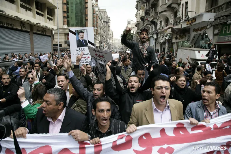 People take part in a symbolic funeral ceremony for the Egyptian journalist, Ahmed Mohammed Mahmoud in Tahrir Square, Cairo, Egypt, Monday, Feb. 7, 2011. The reporter who was shot during clashes a week ago died of his wo...