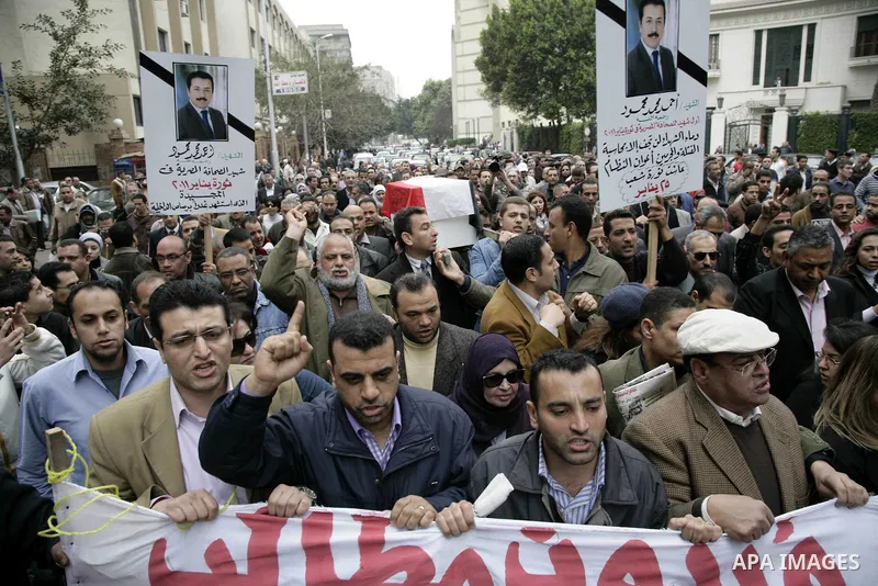 People carry a symbolic coffin of Egyptian journalist Ahmed Mohammed Mahmoud, in symbolic funeral ceremony in Tahrir Square, Cairo, Egypt, Monday, Feb. 7, 2011. The reporter who was shot during clashes a week ago died of...