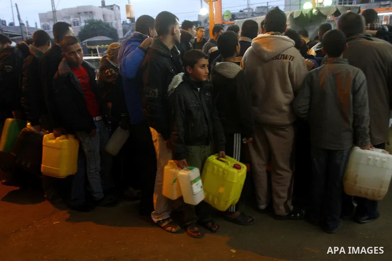 Palestinians wait to fill petrol in containers at a petrol station in Gaza city on Feb. 7, 2011. Gaza Strip residents flocked to petrol stations after clashes in neighbouring Egypt hampered smugglers ferrying fuel suppli...