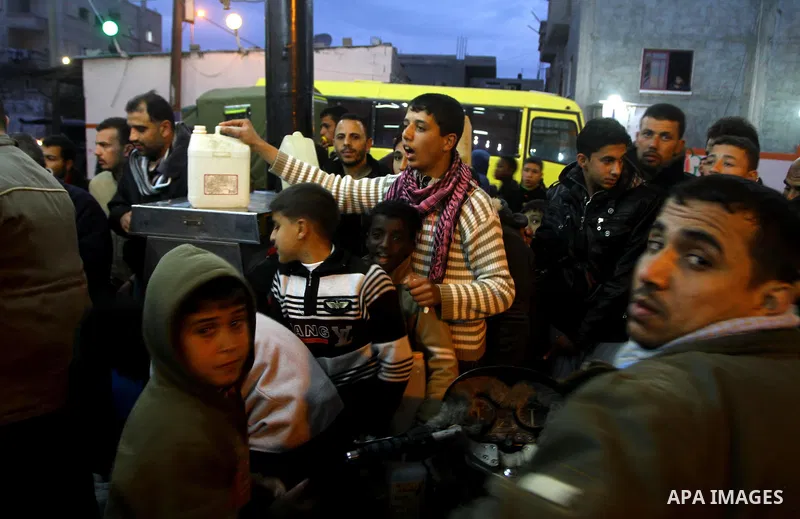Palestinians wait to fill petrol in containers at a petrol station in Gaza city on Feb. 7, 2011. Gaza Strip residents flocked to petrol stations after clashes in neighbouring Egypt hampered smugglers ferrying fuel suppli...