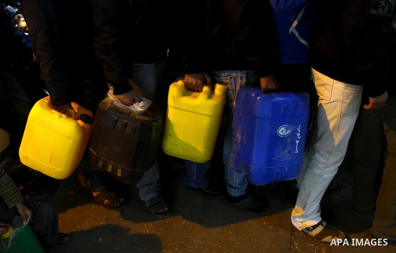 Palestinians wait to fill petrol in containers at a petrol station in Gaza city on Feb. 7, 2011. Gaza Strip residents flocked to petrol stations after clashes in neighbouring Egypt hampered smugglers ferrying fuel suppli...