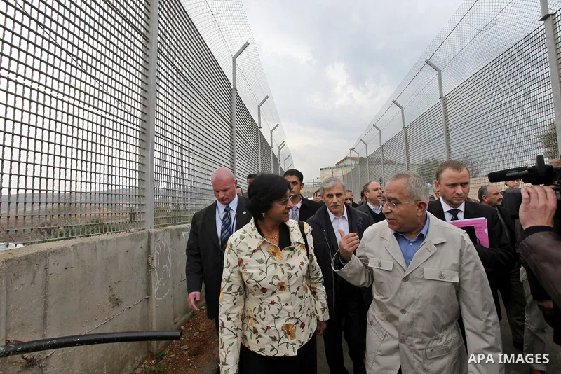 U.N. High Commissioner for Human Rights Navi Pillay and Palestinian prime minister Salam Fayyad visit the Sabri Gareeb Palestinian family home which is situated in the center of the settlement just south of Ramallah in t...