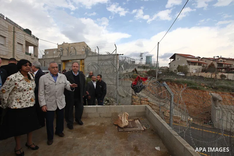 U.N. High Commissioner for Human Rights Navi Pillay and Palestinian prime minister Salam Fayyad visit the Sabri Gareeb Palestinian family home which is situated in the center of the settlement just south of Ramallah in t...