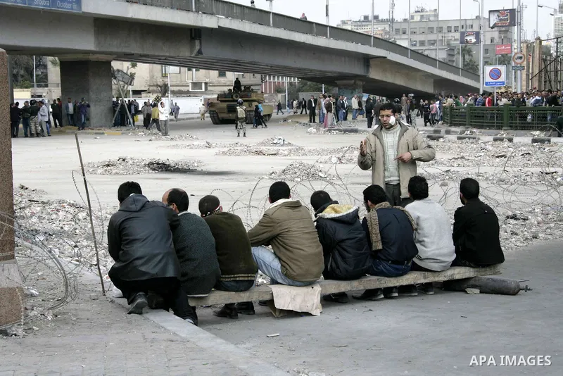 Anti-government protesters take part in demonstrations in Tahrir Square in downtown Cairo, Egypt, Tuesday, Feb. 8, 2011. Protesters appear to have settled in for a long standoff, turning Tahrir Square into a makeshift vi...
