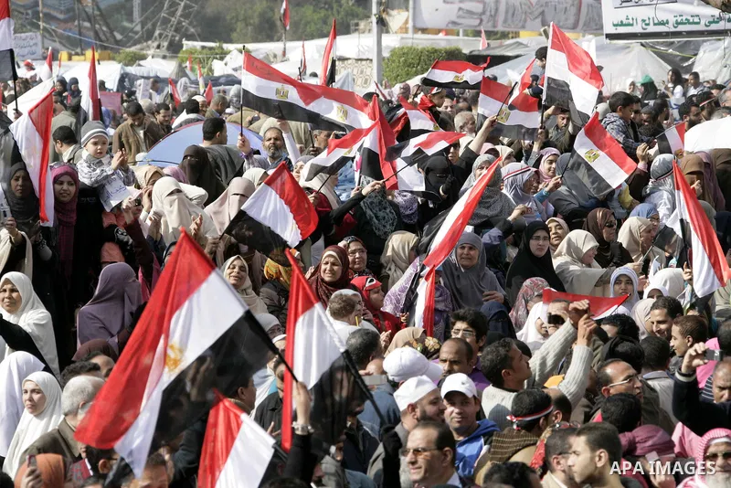 Anti-government protesters take part in demonstrations in Tahrir Square in downtown Cairo, Egypt, Tuesday, Feb. 8, 2011. Protesters appear to have settled in for a long standoff, turning Tahrir Square into a makeshift vi...