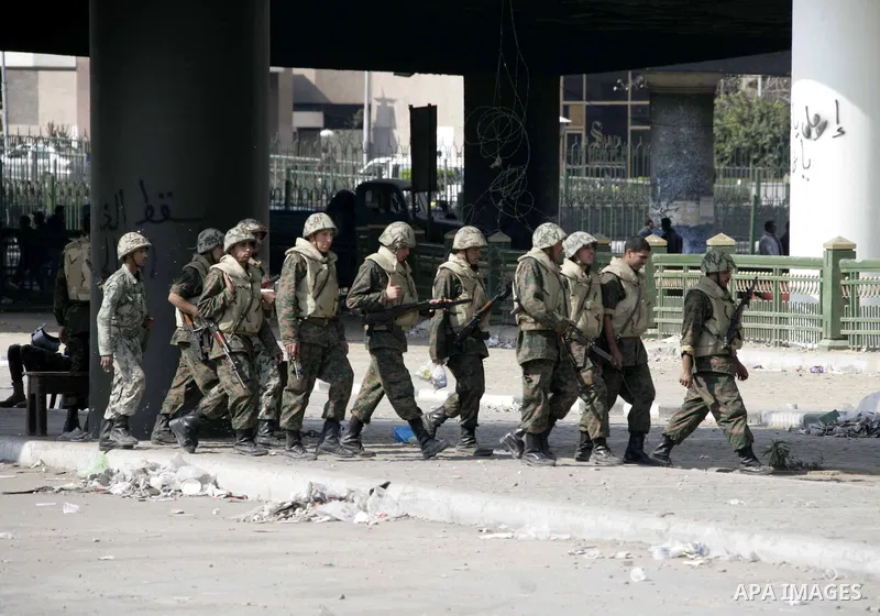 Egyptian soldiers take position during a demonstrations in Tahrir Square in downtown Cairo, Egypt, Tuesday, Feb. 8, 2011. Protesters appear to have settled in for a long standoff, turning Tahrir Square into a makeshift v...