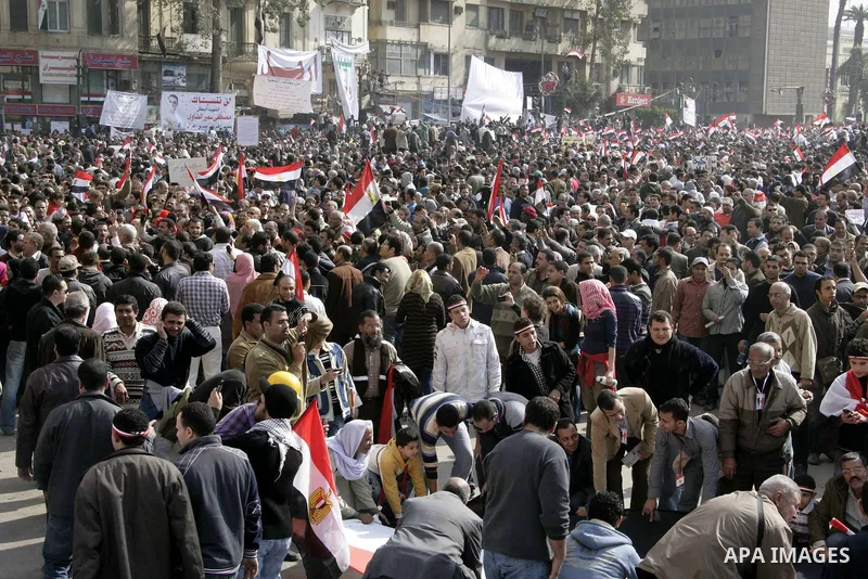 Anti-government protesters take part in demonstrations in Tahrir Square in downtown Cairo, Egypt, Tuesday, Feb. 8, 2011. Protesters appear to have settled in for a long standoff, turning Tahrir Square into a makeshift vi...
