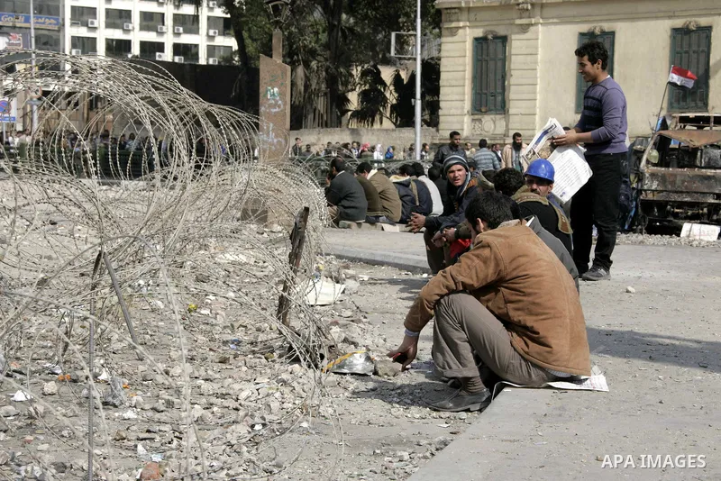Anti-government protesters take part in demonstrations in Tahrir Square in downtown Cairo, Egypt, Tuesday, Feb. 8, 2011. Protesters appear to have settled in for a long standoff, turning Tahrir Square into a makeshift vi...
