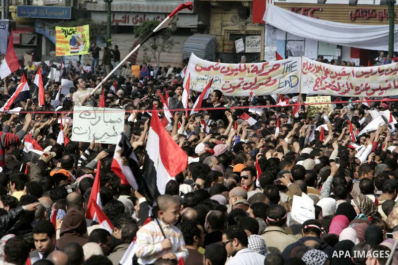 Anti-government protesters take part in demonstrations in Tahrir Square in downtown Cairo, Egypt, Tuesday, Feb. 8, 2011. Protesters appear to have settled in for a long standoff, turning Tahrir Square into a makeshift vi...
