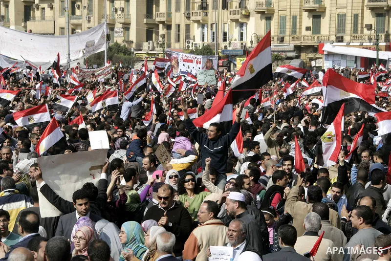 Anti-government protesters take part in demonstrations in Tahrir Square in downtown Cairo, Egypt, Tuesday, Feb. 8, 2011. Protesters appear to have settled in for a long standoff, turning Tahrir Square into a makeshift vi...