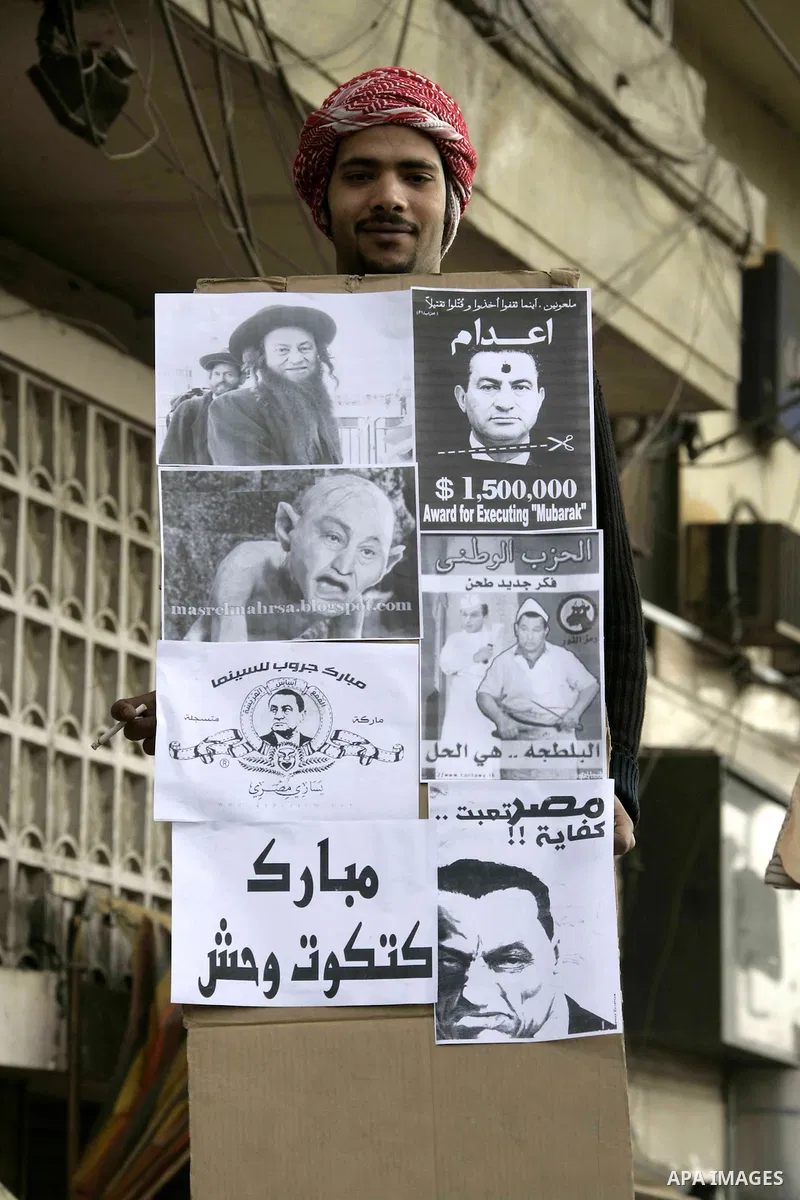 Anti-government protesters take part in demonstrations in Tahrir Square in downtown Cairo, Egypt, Tuesday, Feb. 8, 2011. Protesters appear to have settled in for a long standoff, turning Tahrir Square into a makeshift vi...