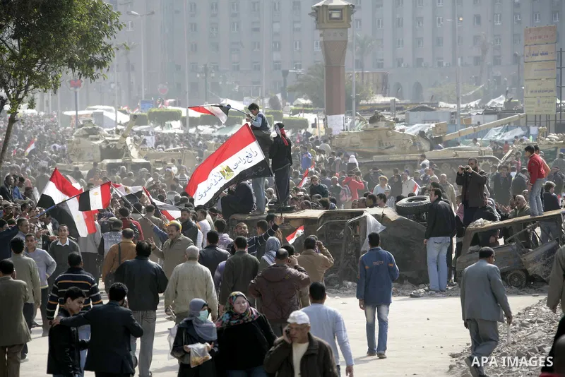 Anti-government protesters take part in demonstrations in Tahrir Square in downtown Cairo, Egypt, Tuesday, Feb. 8, 2011. Protesters appear to have settled in for a long standoff, turning Tahrir Square into a makeshift vi...