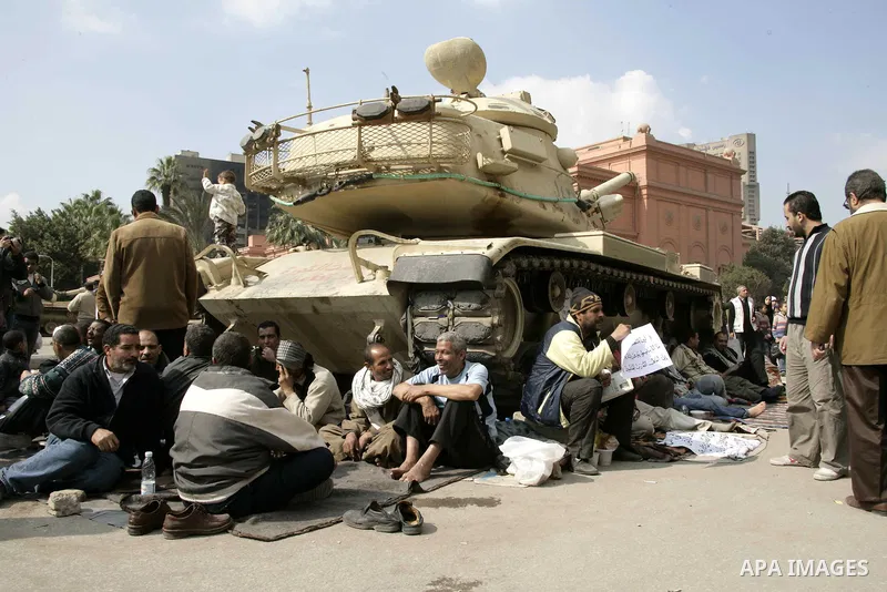 Anti-government protesters take part in demonstrations in Tahrir Square in downtown Cairo, Egypt, Tuesday, Feb. 8, 2011. Protesters appear to have settled in for a long standoff, turning Tahrir Square into a makeshift vi...