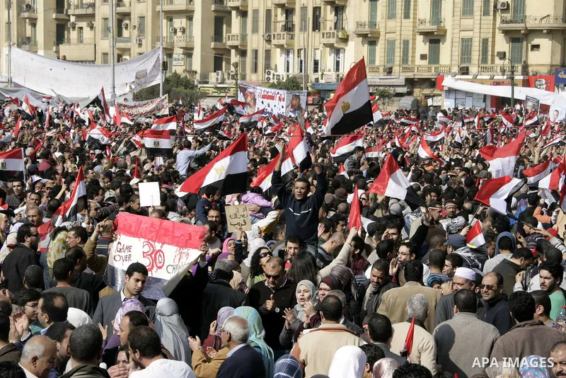 Anti-government protesters take part in demonstrations in Tahrir Square in downtown Cairo, Egypt, Tuesday, Feb. 8, 2011. Protesters appear to have settled in for a long standoff, turning Tahrir Square into a makeshift vi...