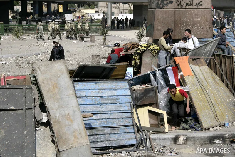 Anti-government protesters take part in demonstrations in Tahrir Square in downtown Cairo, Egypt, Tuesday, Feb. 8, 2011. Protesters appear to have settled in for a long standoff, turning Tahrir Square into a makeshift vi...