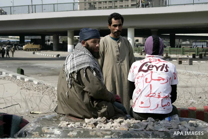 Anti-government protesters take part in demonstrations in Tahrir Square in downtown Cairo, Egypt, Tuesday, Feb. 8, 2011. Protesters appear to have settled in for a long standoff, turning Tahrir Square into a makeshift vi...