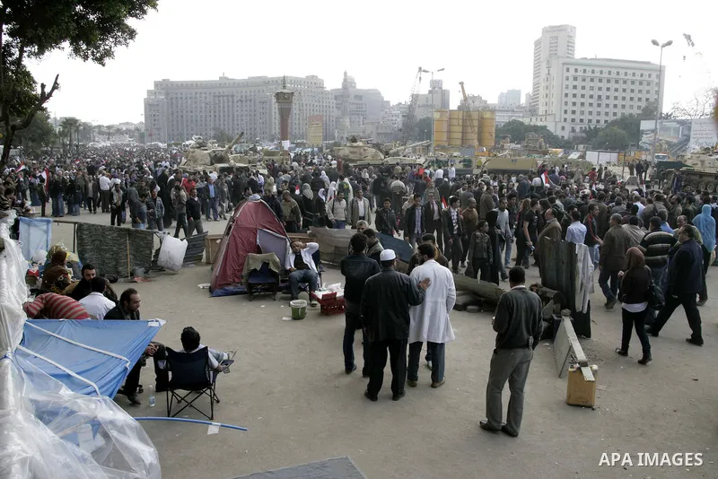 Anti-government protesters take part in demonstrations in Tahrir Square in downtown Cairo, Egypt, Tuesday, Feb. 8, 2011. Protesters appear to have settled in for a long standoff, turning Tahrir Square into a makeshift vi...