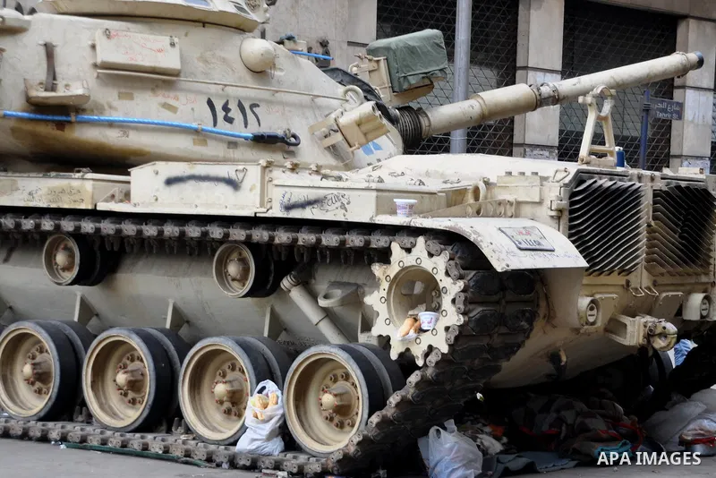 Anti-government protesters put their belongings under a tank during demonstrations in Tahrir Square in downtown Cairo, Egypt, Tuesday, Feb. 8, 2011. Protesters appear to have settled in for a long standoff, turning Tahri...