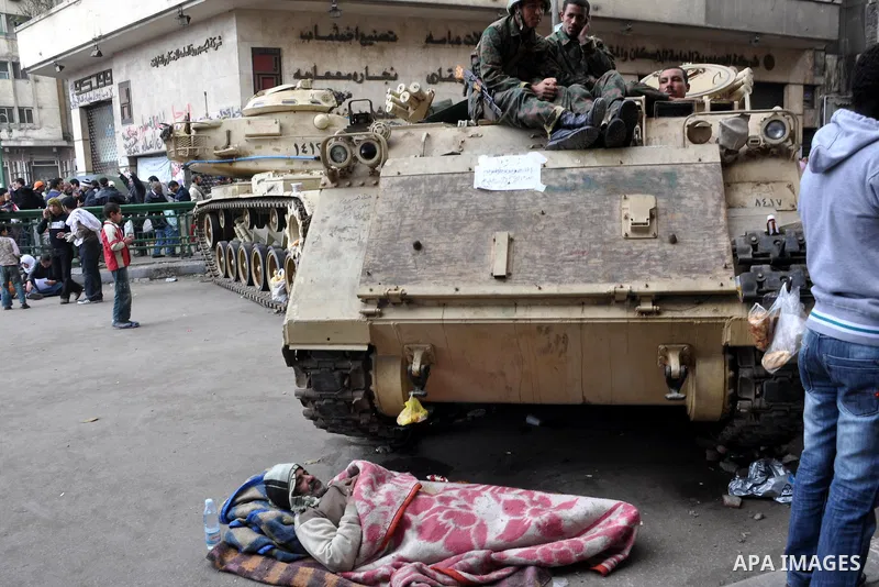 Anti-government protesters take part in demonstrations in Tahrir Square in downtown Cairo, Egypt, Tuesday, Feb. 8, 2011. Protesters appear to have settled in for a long standoff, turning Tahrir Square into a makeshift vi...