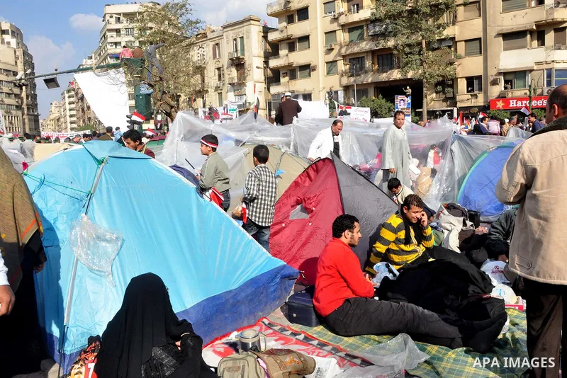 Anti-government protesters take part in demonstrations in Tahrir Square in downtown Cairo, Egypt, Tuesday, Feb. 8, 2011. Protesters appear to have settled in for a long standoff, turning Tahrir Square into a makeshift vi...