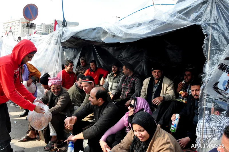 Anti-government protesters take part in demonstrations in Tahrir Square in downtown Cairo, Egypt, Tuesday, Feb. 8, 2011. Protesters appear to have settled in for a long standoff, turning Tahrir Square into a makeshift vi...
