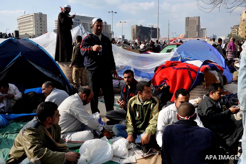 Anti-government protesters take part in demonstrations in Tahrir Square in downtown Cairo, Egypt, Tuesday, Feb. 8, 2011. Protesters appear to have settled in for a long standoff, turning Tahrir Square into a makeshift vi...