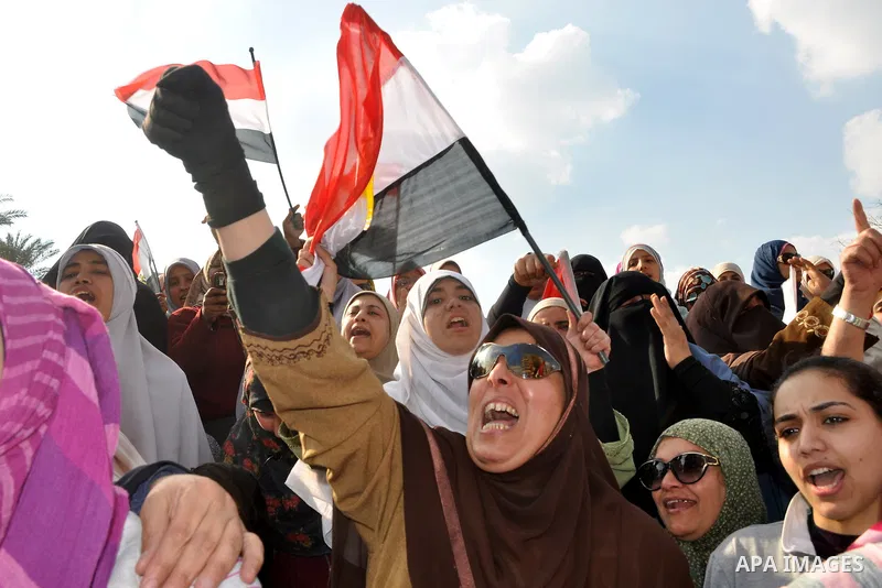 Anti-government protesters take part in demonstrations in Tahrir Square in downtown Cairo, Egypt, Tuesday, Feb. 8, 2011. Protesters appear to have settled in for a long standoff, turning Tahrir Square into a makeshift vi...