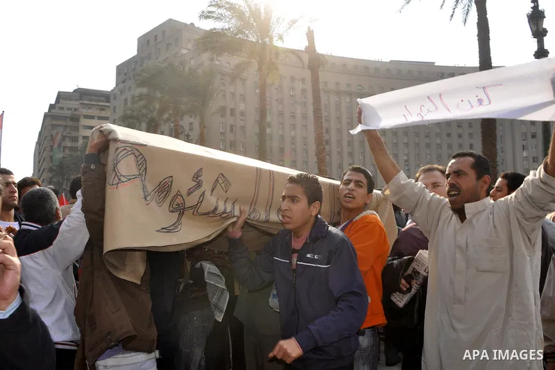 Anti-government protesters take part in demonstrations in Tahrir Square in downtown Cairo, Egypt, Tuesday, Feb. 8, 2011. Protesters appear to have settled in for a long standoff, turning Tahrir Square into a makeshift vi...