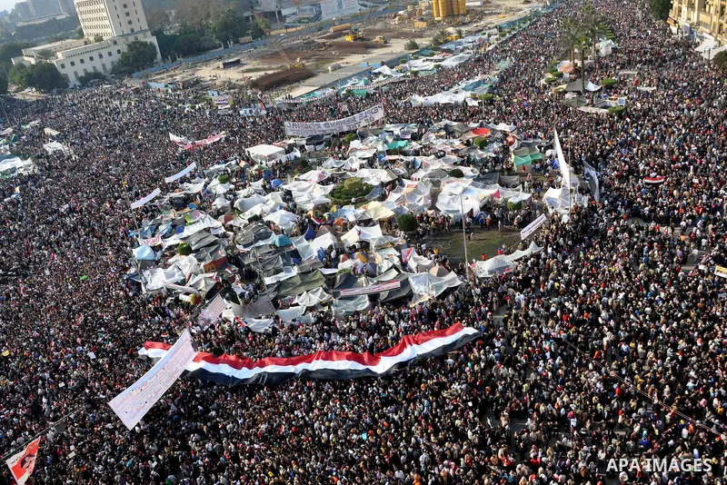 Anti-government protesters take part in demonstrations in Tahrir Square in downtown Cairo, Egypt, Tuesday, Feb. 8, 2011. Protesters appear to have settled in for a long standoff, turning Tahrir Square into a makeshift vi...