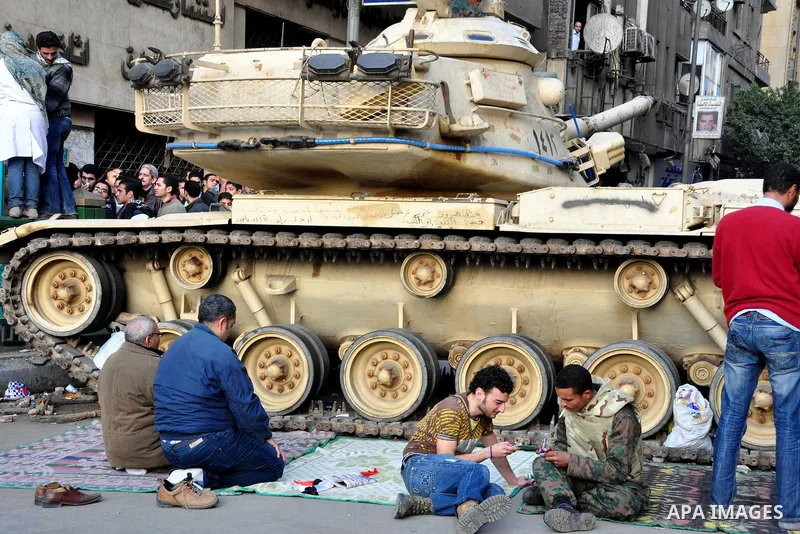 Anti-government protesters take part in demonstrations in Tahrir Square in downtown Cairo, Egypt, Tuesday, Feb. 8, 2011. Protesters appear to have settled in for a long standoff, turning Tahrir Square into a makeshift vi...