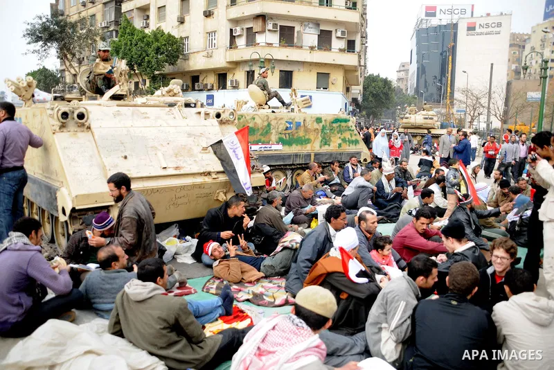 Anti-government protesters take part in demonstrations in Tahrir Square in downtown Cairo, Egypt, Tuesday, Feb. 8, 2011. Protesters appear to have settled in for a long standoff, turning Tahrir Square into a makeshift vi...